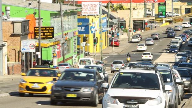 Once a vibrant shopping area, Parramatta Road has become parking lot of traffic and boarded up shops.