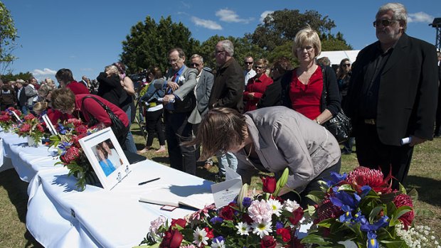 Mourners sign memorial books for six people killed in a vintage plane crash.