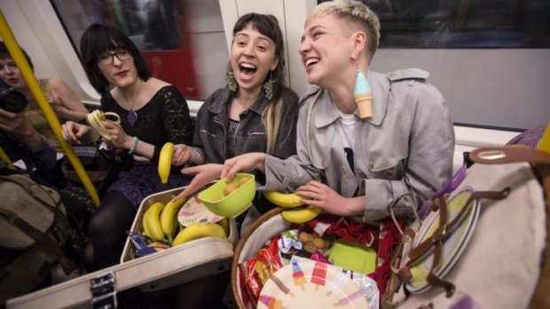 Women eat on a Circle Line Underground train in protest at the 'Women who eat on tubes' website.
