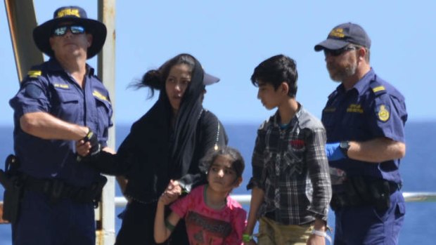 Landing: Asylum seeker families are offloaded from the customs vessel Triton on Thursday.