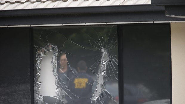 Broken windows at a house in Hallam after Saturday's terror raids.