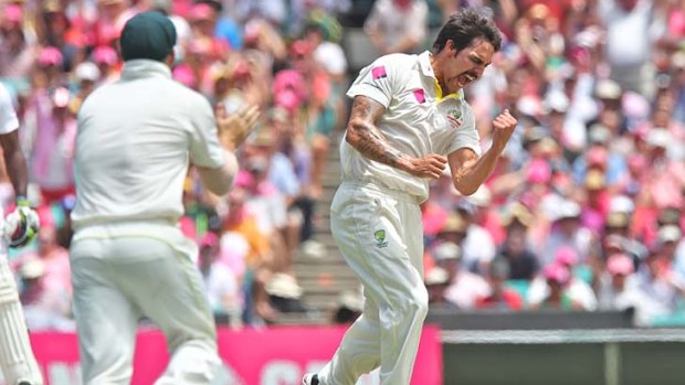 Fired up: Mitchell Johnson celebrates getting Alastair Cook's wicket.