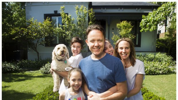 Matt Mullins with his family, Tom (holding Buddy the dog), Lulu (front), Sophie (obscured) and Cait.