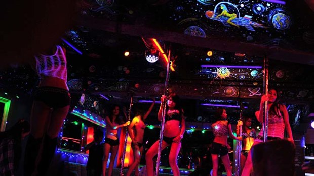 Bangkok's red-light districts - where scantily-clad girls dance on stage and touts compete to lure visitors into shows involving bananas and ping pong balls - are firmly on the tourist trail.
