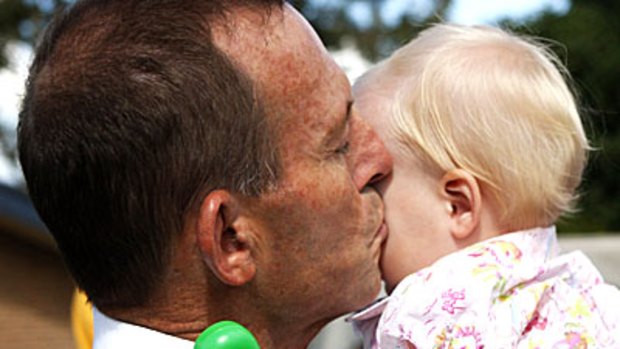 Tony Abbott puckers up for Faith Hodgson — but is silent on the Rudd parental leave plan.