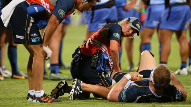 David Pocock receives treatment on his knee against the Force.