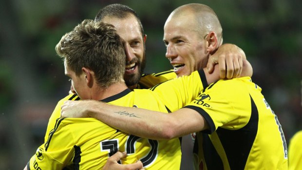 Heartbreaker: Wellington's Stein Huysegems (right) is congratulated by teammates after his goal against Melbourne Heart.