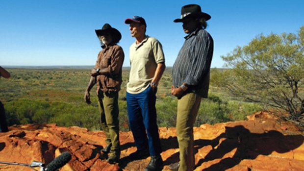 Walkabout ... Tony Abbott with traditional owners Anselem Impu, left, and Hubert Malbunka.