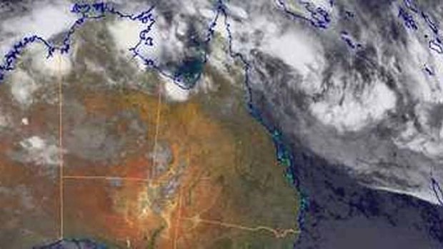 A satellite image shows the weather system intensifying off the Queensland coast.