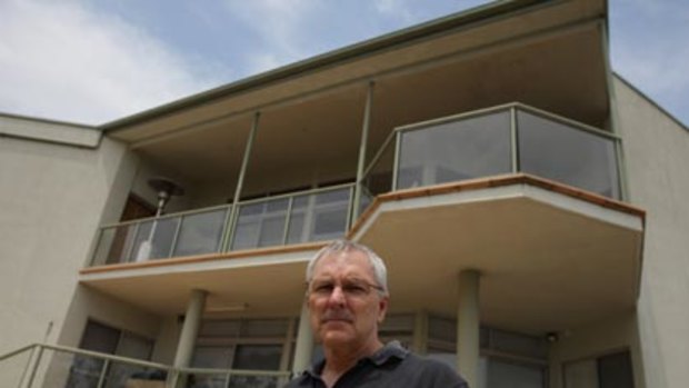 From the ashes...Phillip Moore and the home he rebuilt to withstand bushfires.