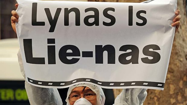 An activist protests outside the Lynas Corprations headquarters in Sydney.