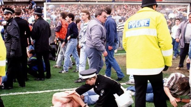 Police and medics help fans at HIllsborough stadium in 1989.