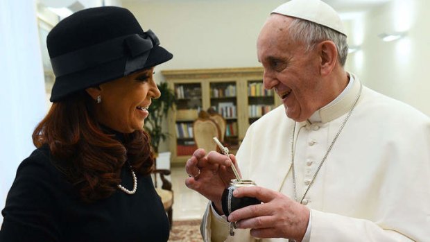 Former adversaries ... Pope Francis receives a gift from Argentina's President, Cristina Kirchner, as they met at the Vatican.