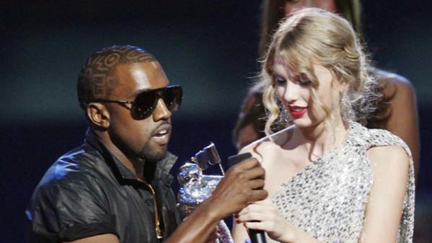 Kanye West takes the microphone from Taylor Swift during last year's VMAs.