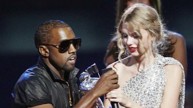 Kanye West takes the microphone from Taylor Swift during last year's VMAs.