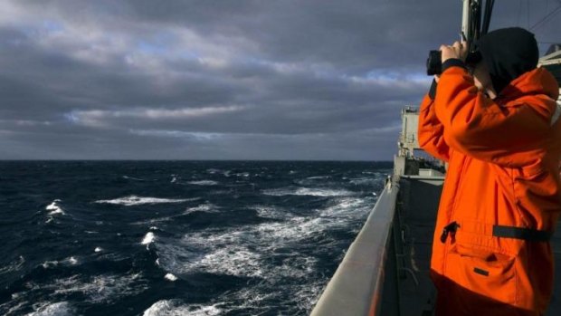 Able Seaman Marine Technician Matthew Oxley stands aboard the Australian Navy ship the HMAS Success looking for debris in the southern Indian Ocean during the search for missing Malaysian Airlines Flight MH370.