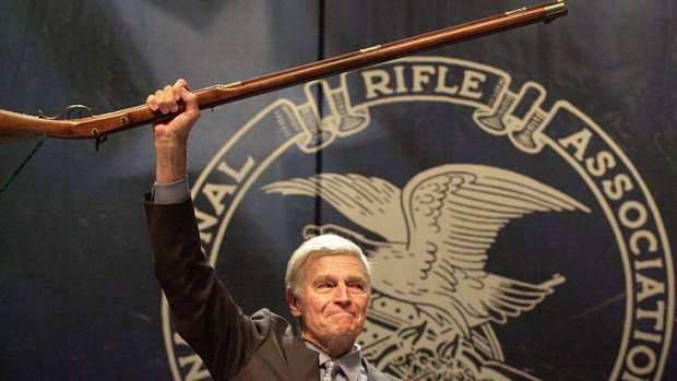 Upholder of gun rights ... former NRA president the late Charlton Heston holds up a musket.