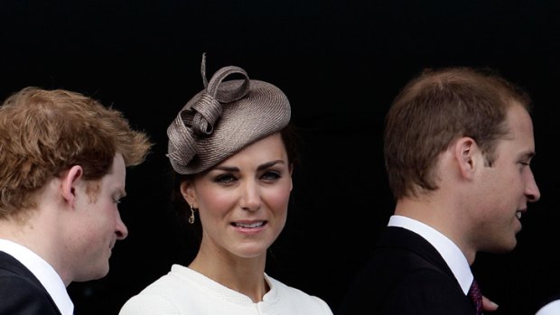 Catherine, Duchess of Cambridge, with her husband Prince William (right) and brother-in-law Prince Harry at the Epsom Derby racing event.