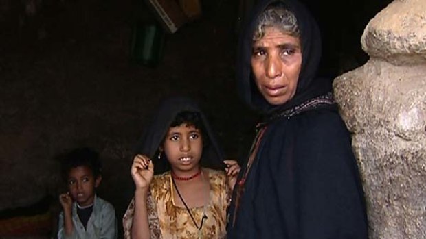 Nejma, mother of Yemeni child bride Ilham al-Ashi, stands with two of her other children.
