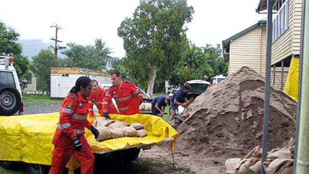 SES volunteers in Cairns fill sand bags to ward off flooding in the north of the state.