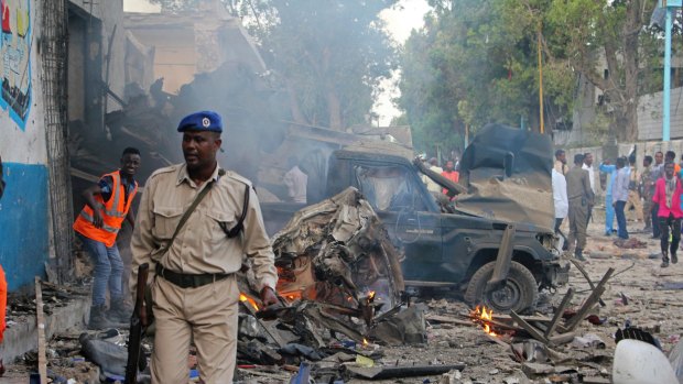 A suicide car bomb exploded outside a popular hotel in Somalia's capital on Saturday, killing at least 10 people and wounding more than 11, while gunfire could be heard inside.