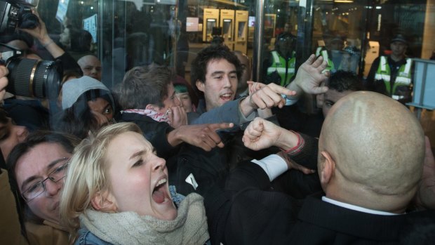 Demonstrators clash with police outside NAB headquarters in Melbourne's Docklands. 