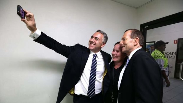 Shadow treasurer Joe Hockey, Carmel Busby and Opposition Leader Tony Abbott take a "selfie" during their visit to a beef processing plant in Queensland during the election campaign.