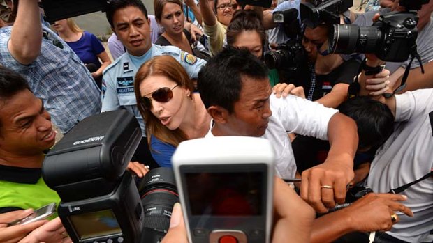 Rebuffed: Schapelle Corby 's sister Mercedes and husband Wayan fight their way through the media pack after visiting her before she was released.