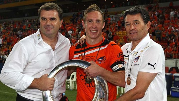 (L-R) Ange Postecoglou, Matthew Smith and Dario Vidosic of the Roar hold the winners trophy after the 2012 A-League Grand Final.