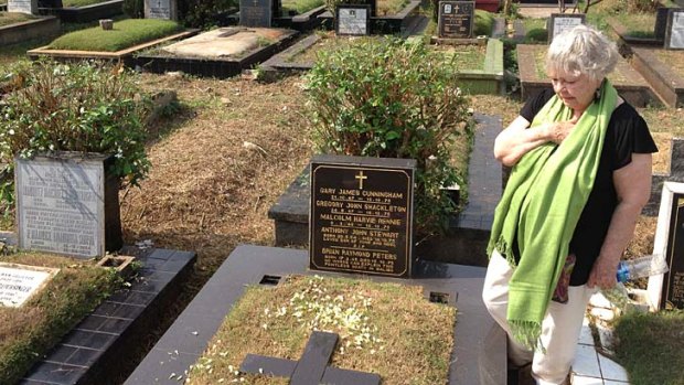 Shirley Shackleton at the grave of her husband Greg, who was killed in East Timor during the Indonesian invasion in 1975.