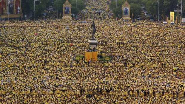 Sea of yellow ... tens of thousands of Thais gather in Bangkok to hear the king's speech.