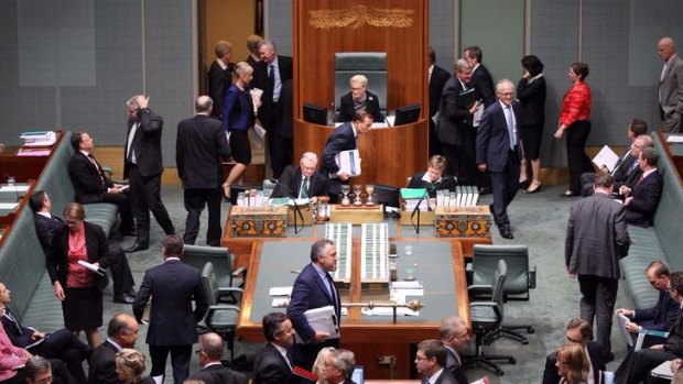 Prime Minister Tony Abbott bows as he votes on a procedure division to deny the opposition a no confidence motion against Madam Speaker Bronwyn Bishop.