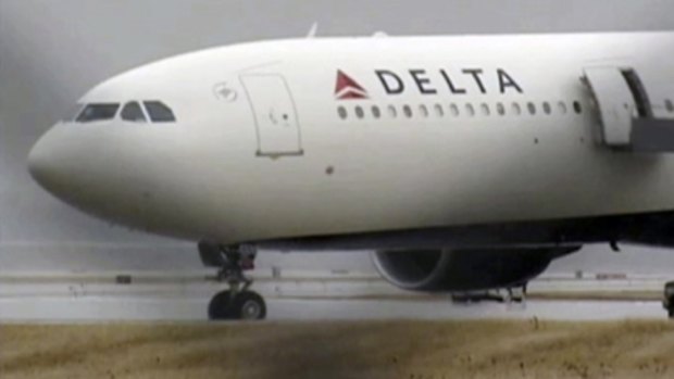 The Delta Airbus 330 airliner sits on a runway at Detroit Metropolitan Airport.