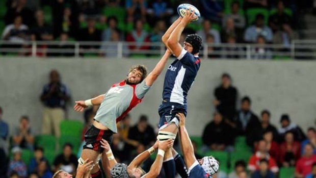 Big men fly ... Melbourne's Kevin O'Neill wins the ball.