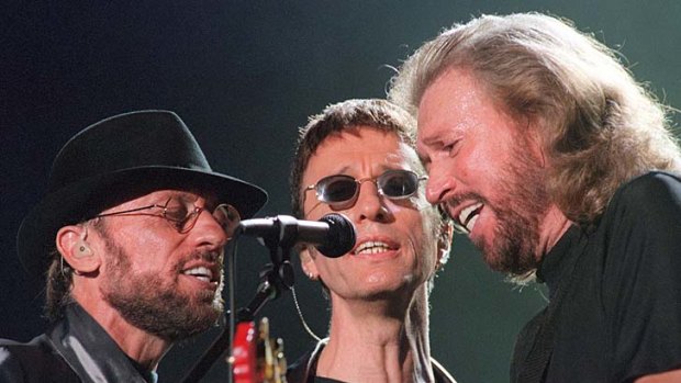The Gibb brothers, Maurice, Robin and Barry, perform at a reunion concert in1999.