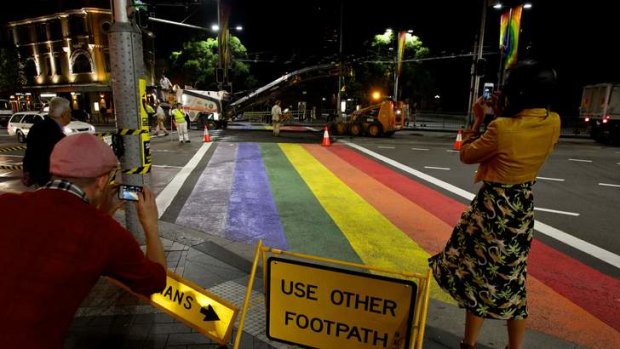 Roadworkers ripping up the rainbow crossing at Taylor Square in Sydney.