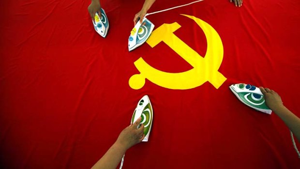 Moving along nicely ... The Chinese Communist Party (flag depicted) is aiming for stable growth.