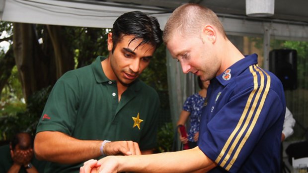Salman Butt of Pakistan inspects Michael Clarke of Australia's tattoo during an Australian and Pakistan cricket teams at Kirribilli House.