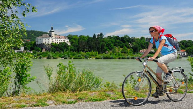 Saddle up: cycling along the Danube with Persenbeug Castle in the background.