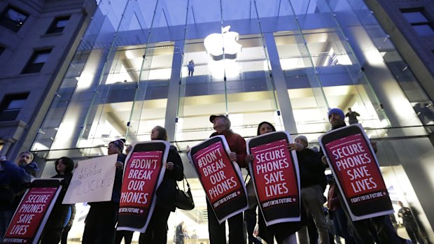 Demonstrators in Boston protest the FBI attempts to require Apple to make it easier to unlock an encrypted iPhone.