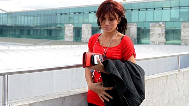 John McAfee's Belizian girlfriend, Samantha Vanegas, waits for his arrival at the Aurora international airport in Guatemala City.