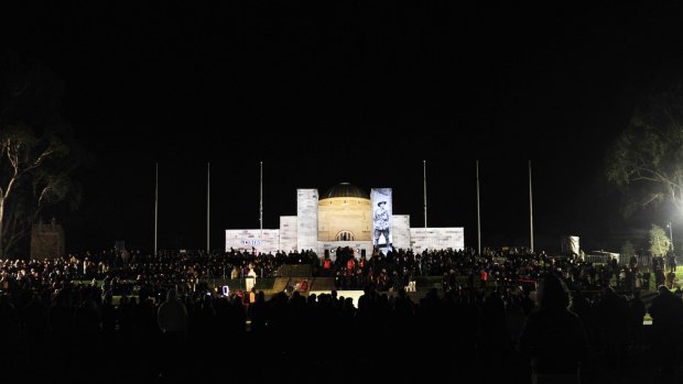 Crowds surround the Australian War Memorial for the solemn dawn service on Anzac Day 2013.