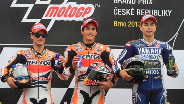 Winner Marc Marquez (centre), second-placed Dani Pedrosa (left) and third-placed Jorge Lorenzo pose on the podium.