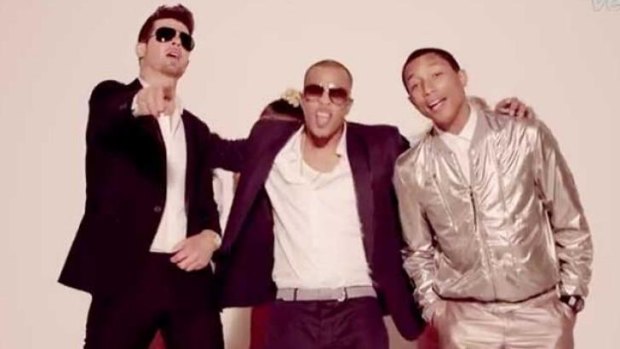 Happier times: Robin Thicke with Pharrell Williams and T.I in the Blurred Lines film clip.