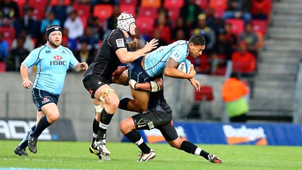Steve Sykes (centre) and Wimpie van der Walt of the Southern Kings tackle Israel Folau during the Super Rugby match on Saturday.