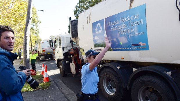 Police guide garbage trucks from Blacktown during the May 2015 protest against the SBS show <i>Struggle Street</i>, before the first episode aired.
