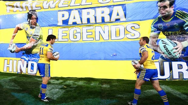 Banner headlines &#8230; Nathan Hindmarsh, left, and Luke Burt prepare to take to the field for the last time at ANZ Stadium last night.