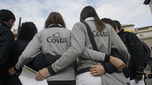 Workers of the Costa Crociere liner take part in the march.