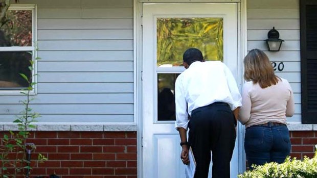 Anyone home? Barack Obama and a campaign volunteer knock on a door in Holland, Ohio.