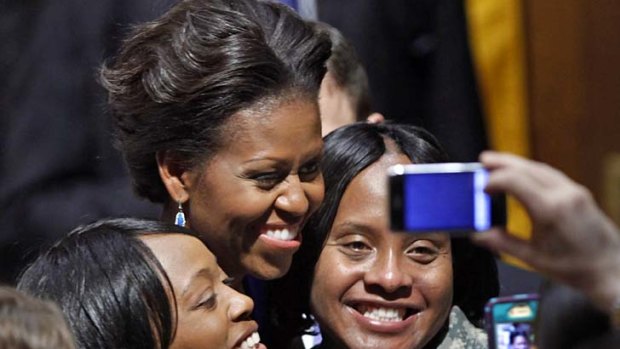 Michelle Obama is all smiles as she poses with US Army sergeants Keisha Whitmore (left) and Tyeir Pritchard-Davis this week.